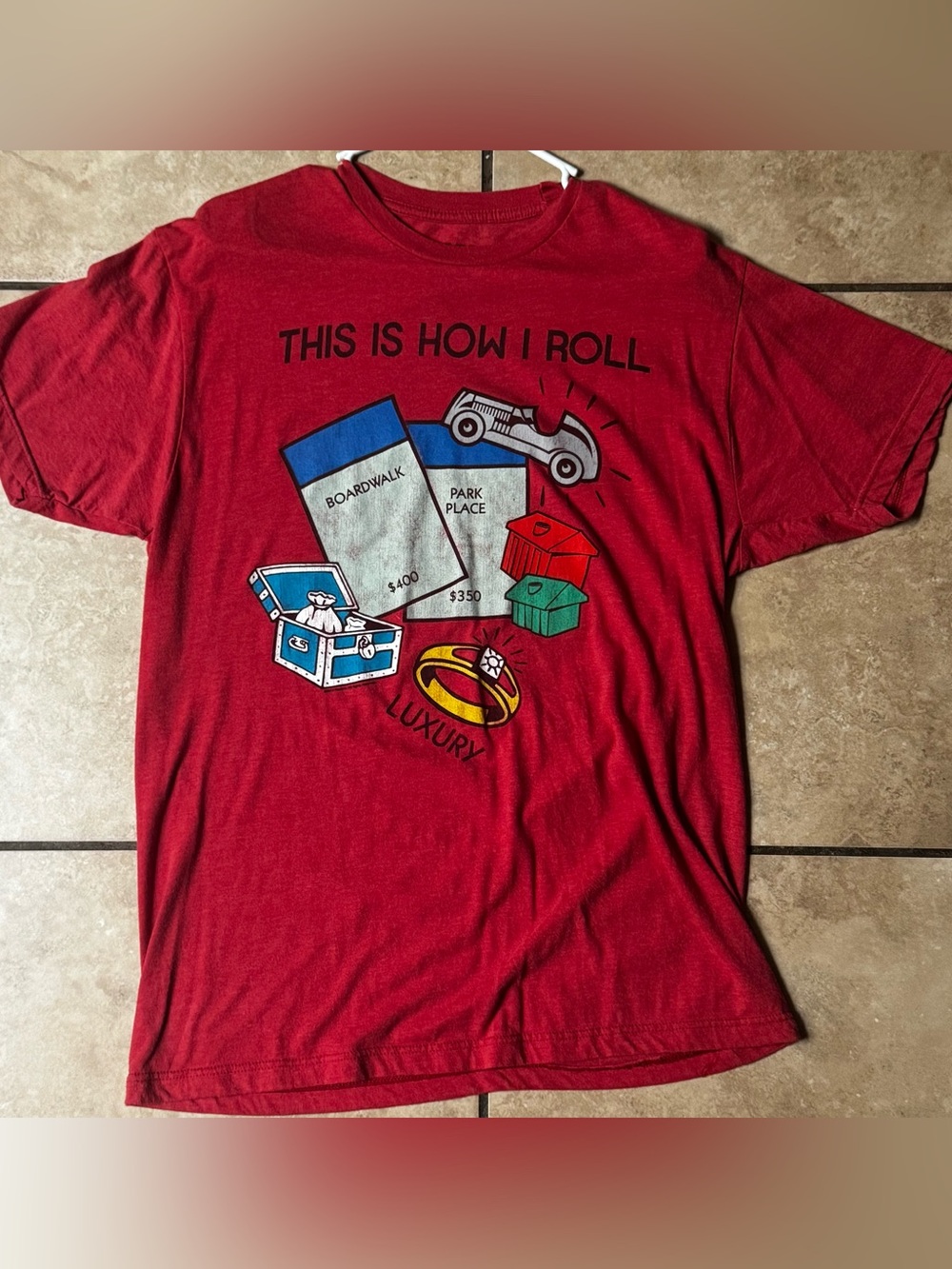 TOPLESS CALIFORNIA Red Short-Sleeve Graphic Tee with 'This Is How I Roll' Print.